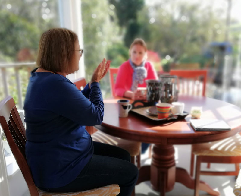 Image of two women sitting at a table